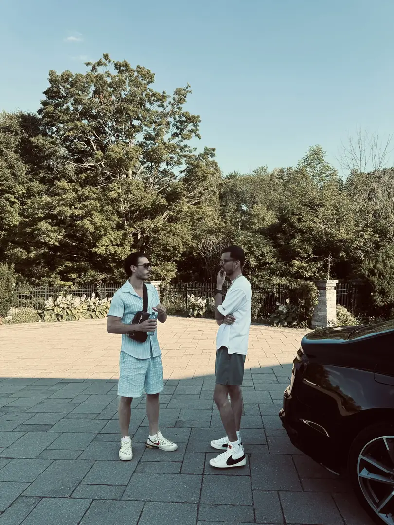 a man in a white hat looking out to the water
