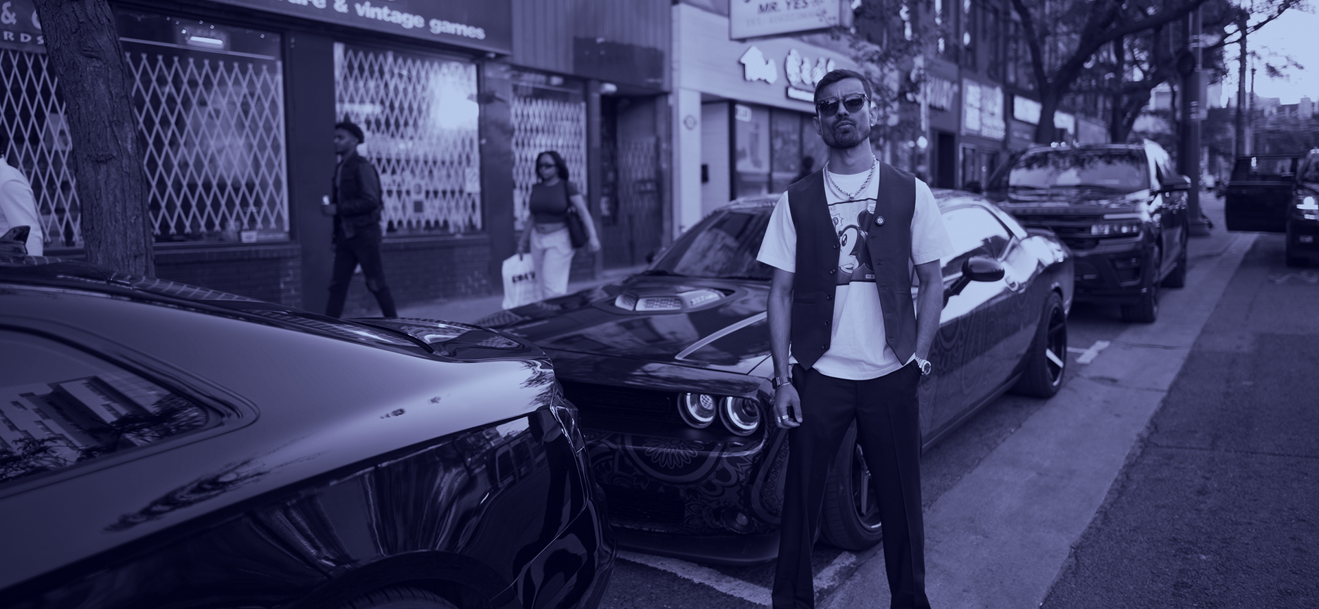 a man sitting at a desk with a microphone and a computer