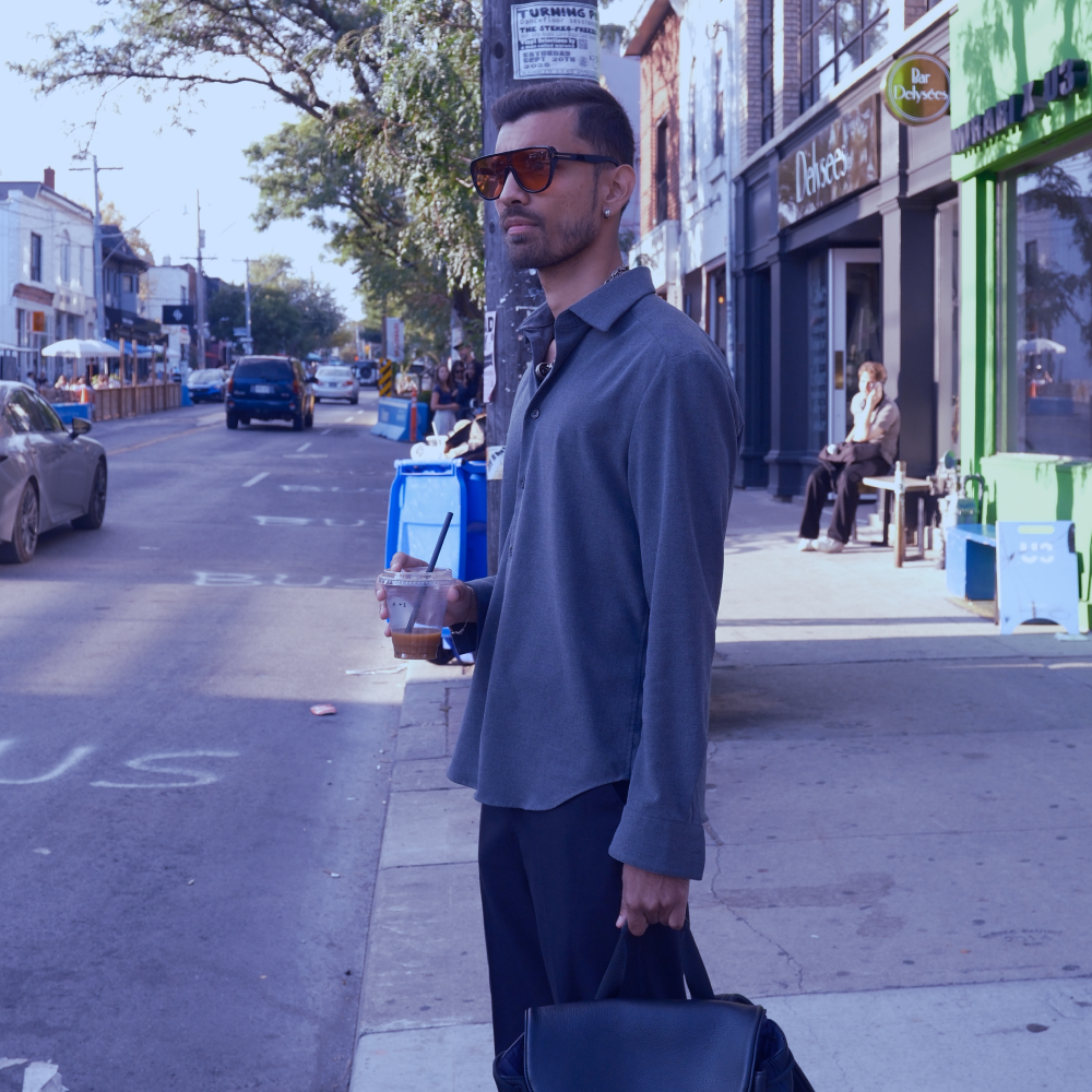 a man sitting on a couch using a tablet